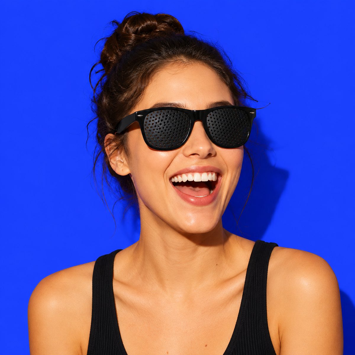 Woman laughing while wearing pinhole glasses